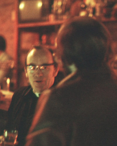 Photo of street minister talking with man in a bar