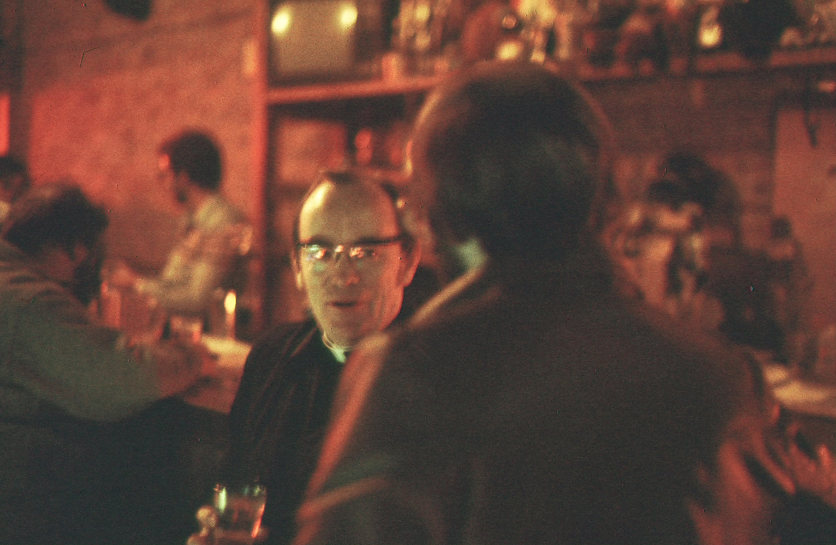 Photo of street minister talking with man in a bar